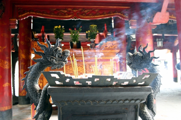 Smoke from incense in a large sandbox before an altar